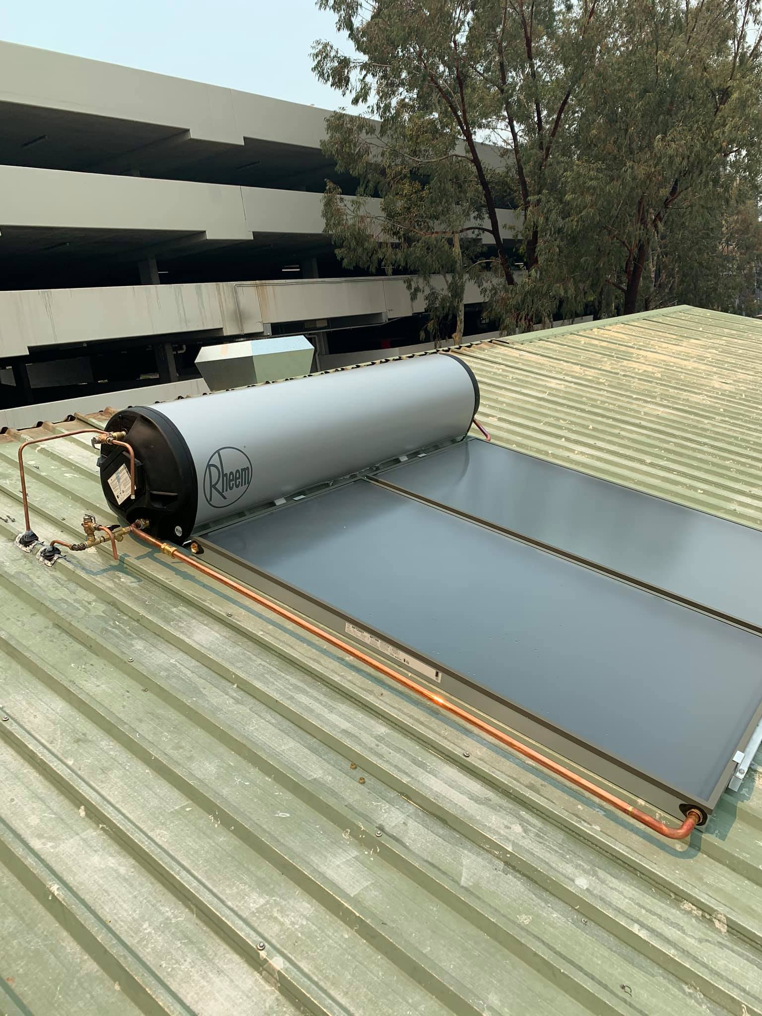 A roof displaying a Rheem solar hot water system
